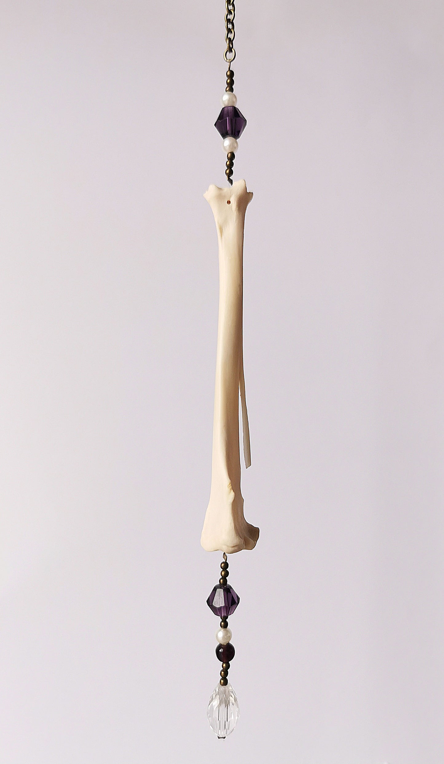Animal bone suncatcher with pearl and purple beads