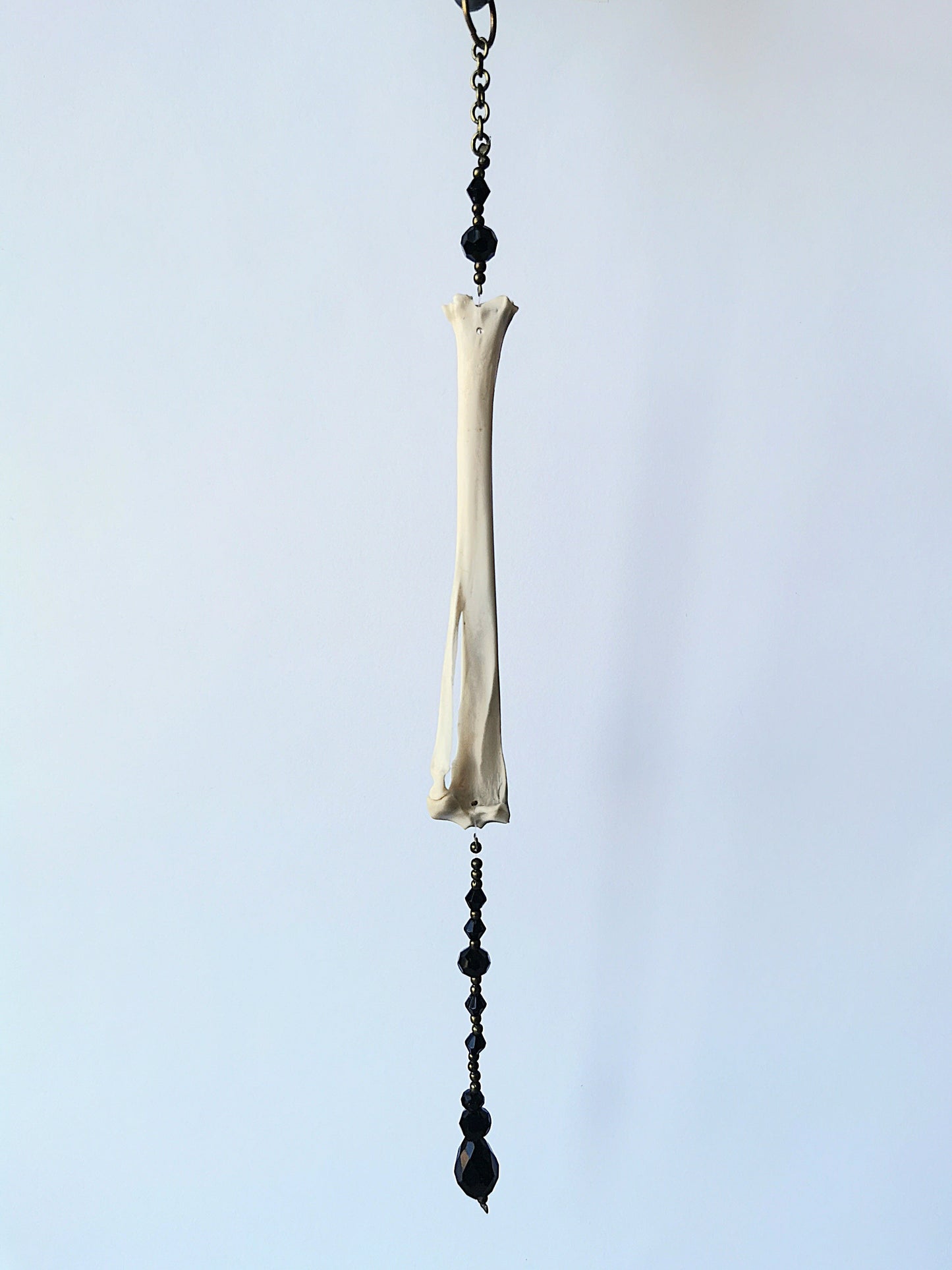 Animal bone suncatcher with black beads