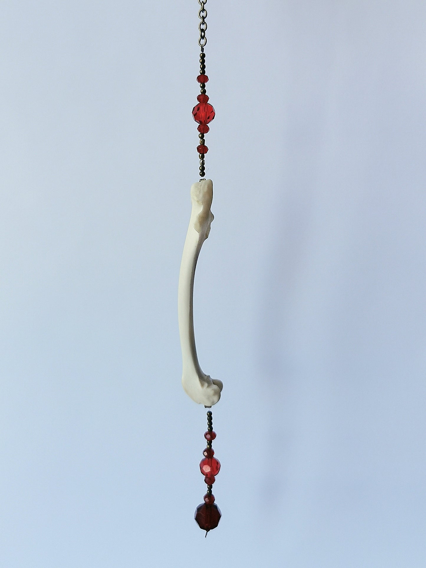 Animal bone suncatcher with red beads