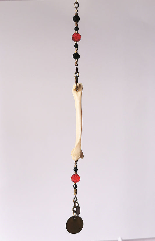 Animal bone suncatcher with red and black beads