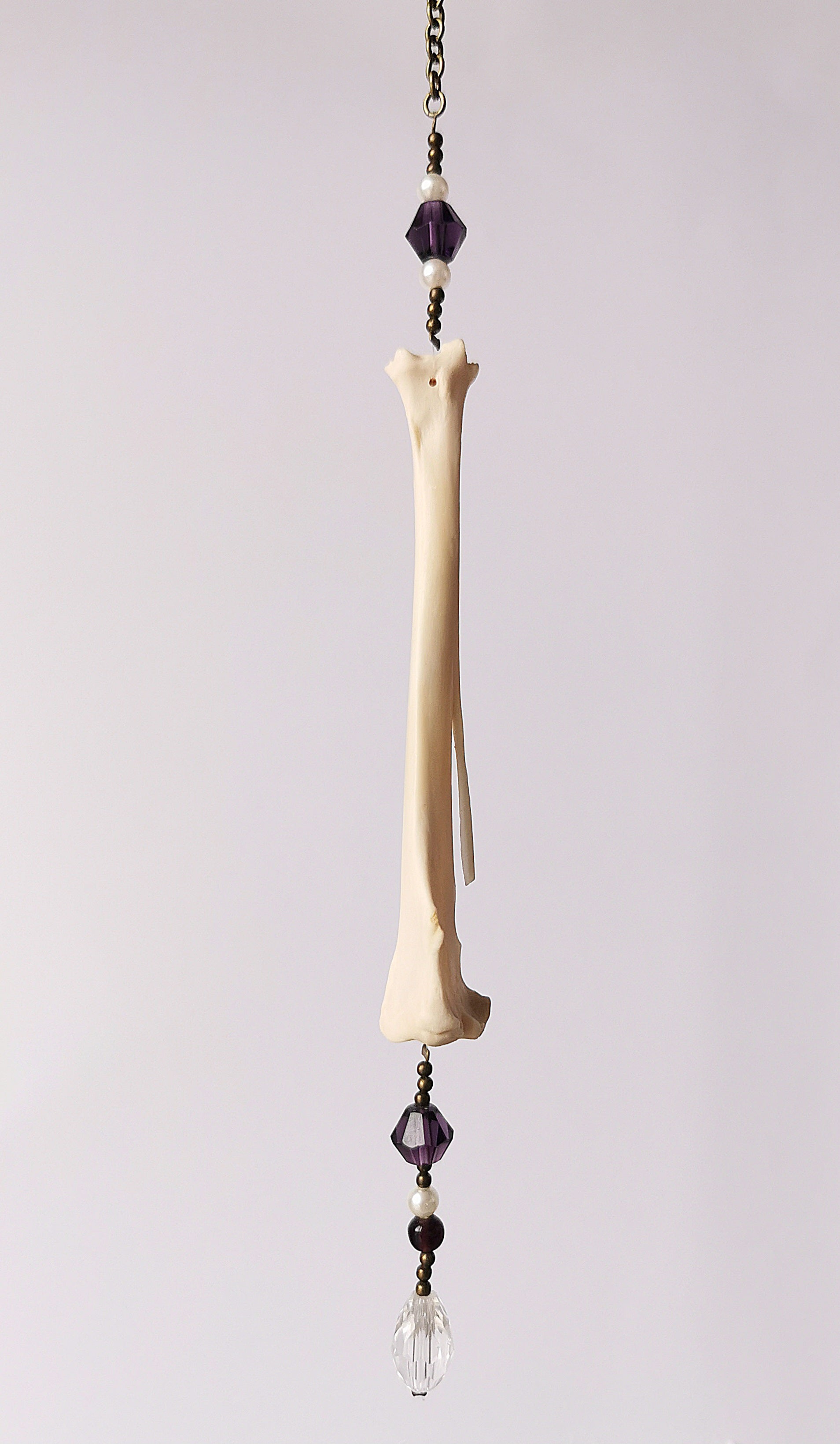 Animal bone suncatcher with pearl and purple beads