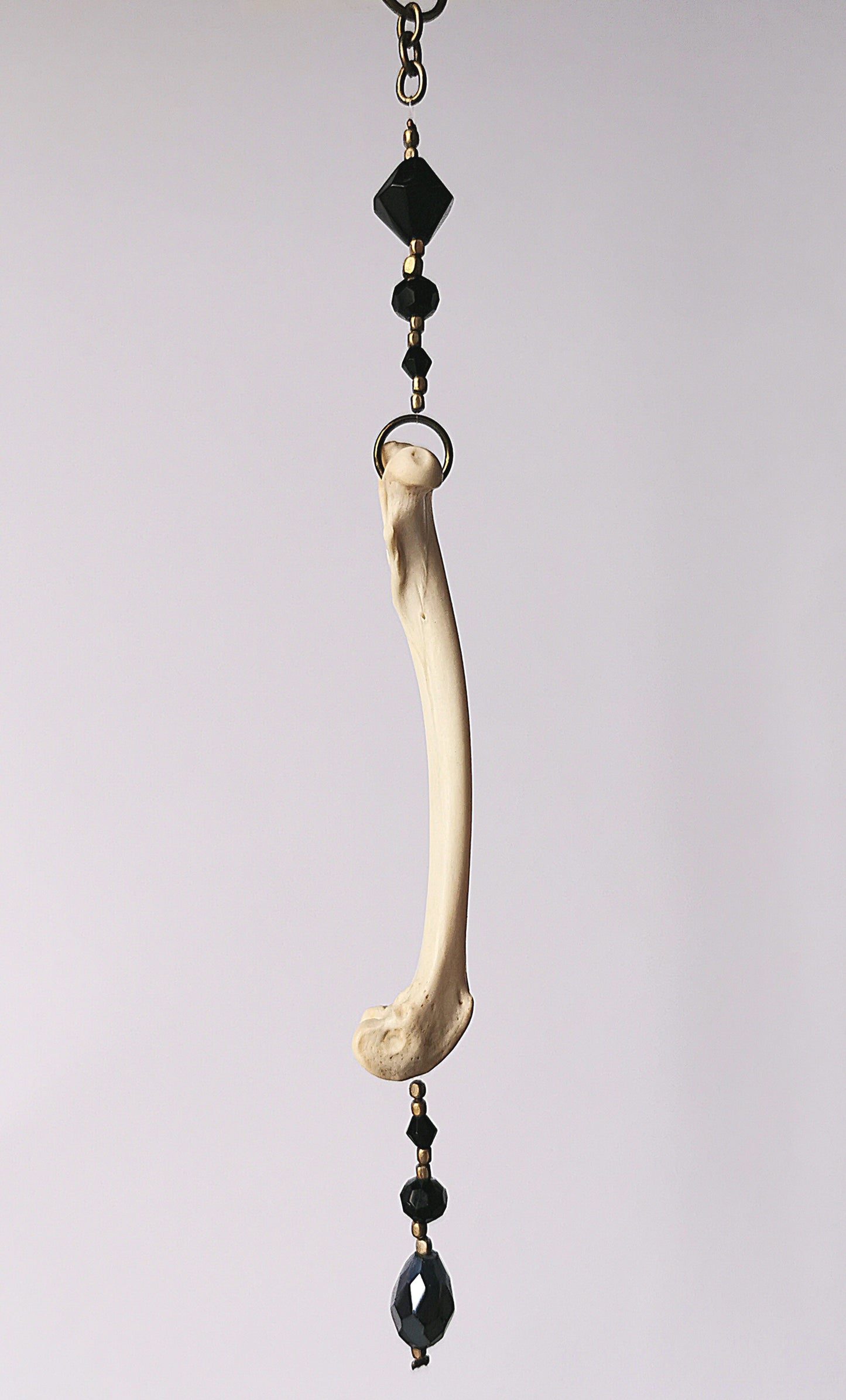 Animal bone suncatcher with black beads