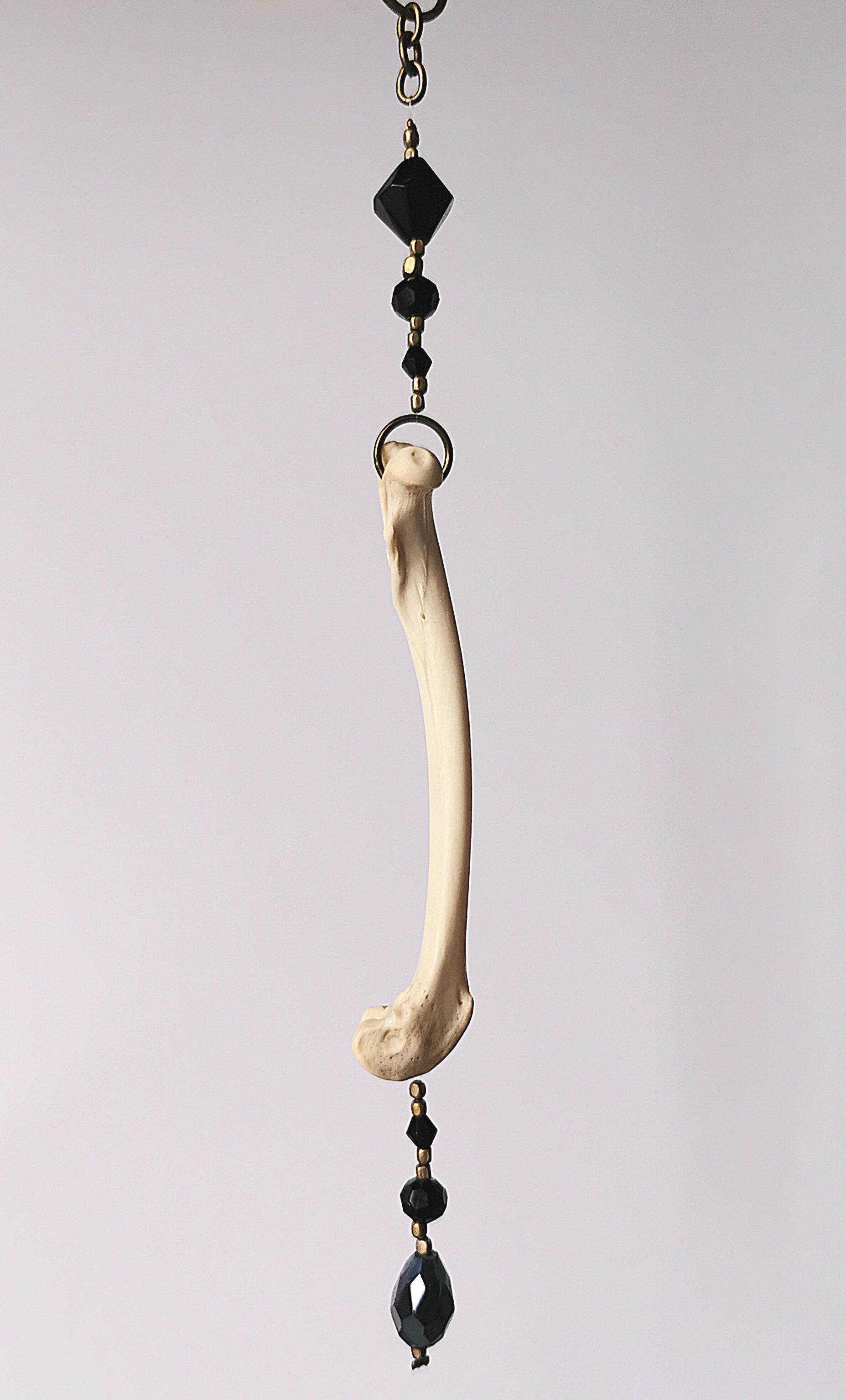 Animal bone suncatcher with black beads