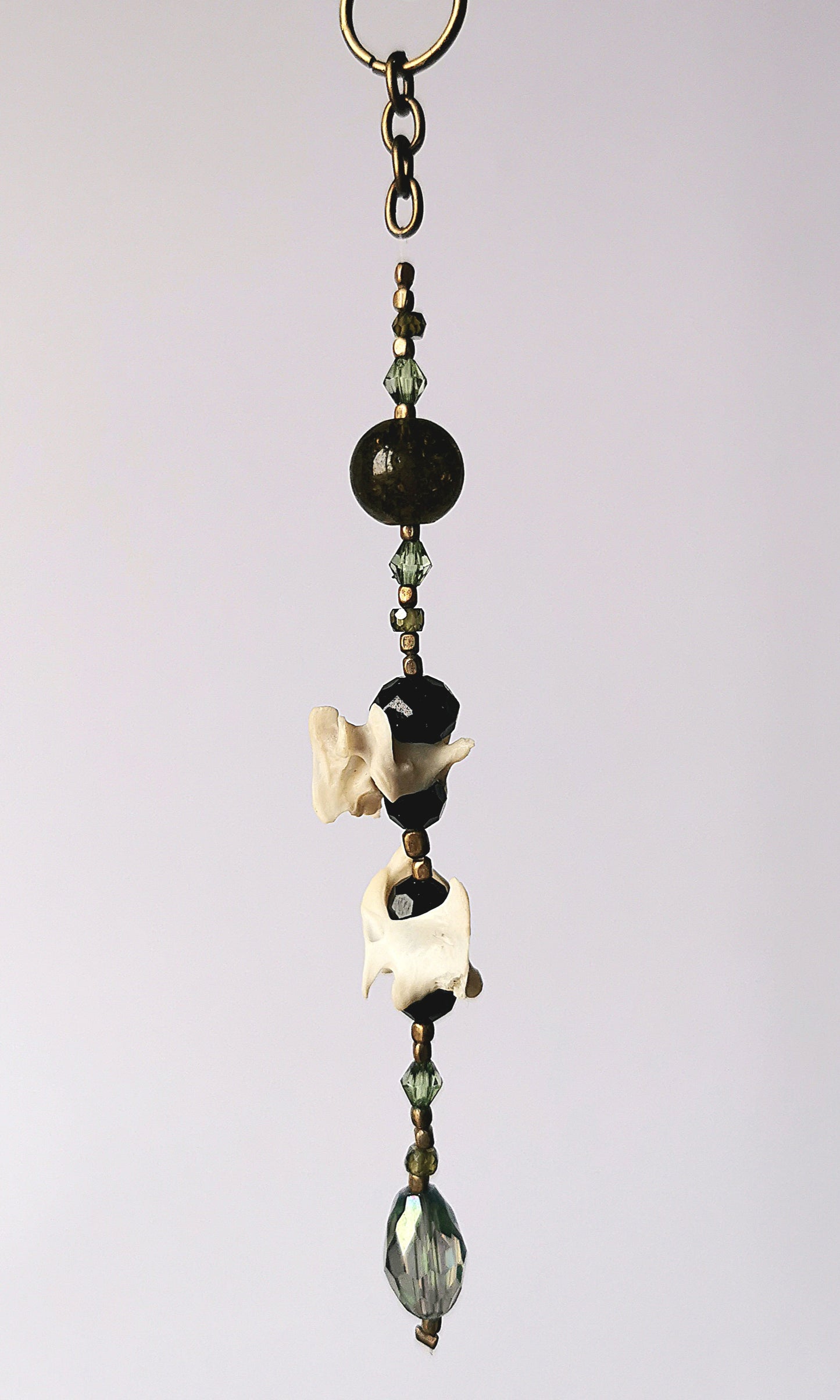 Animal bone suncatcher with green and black beads