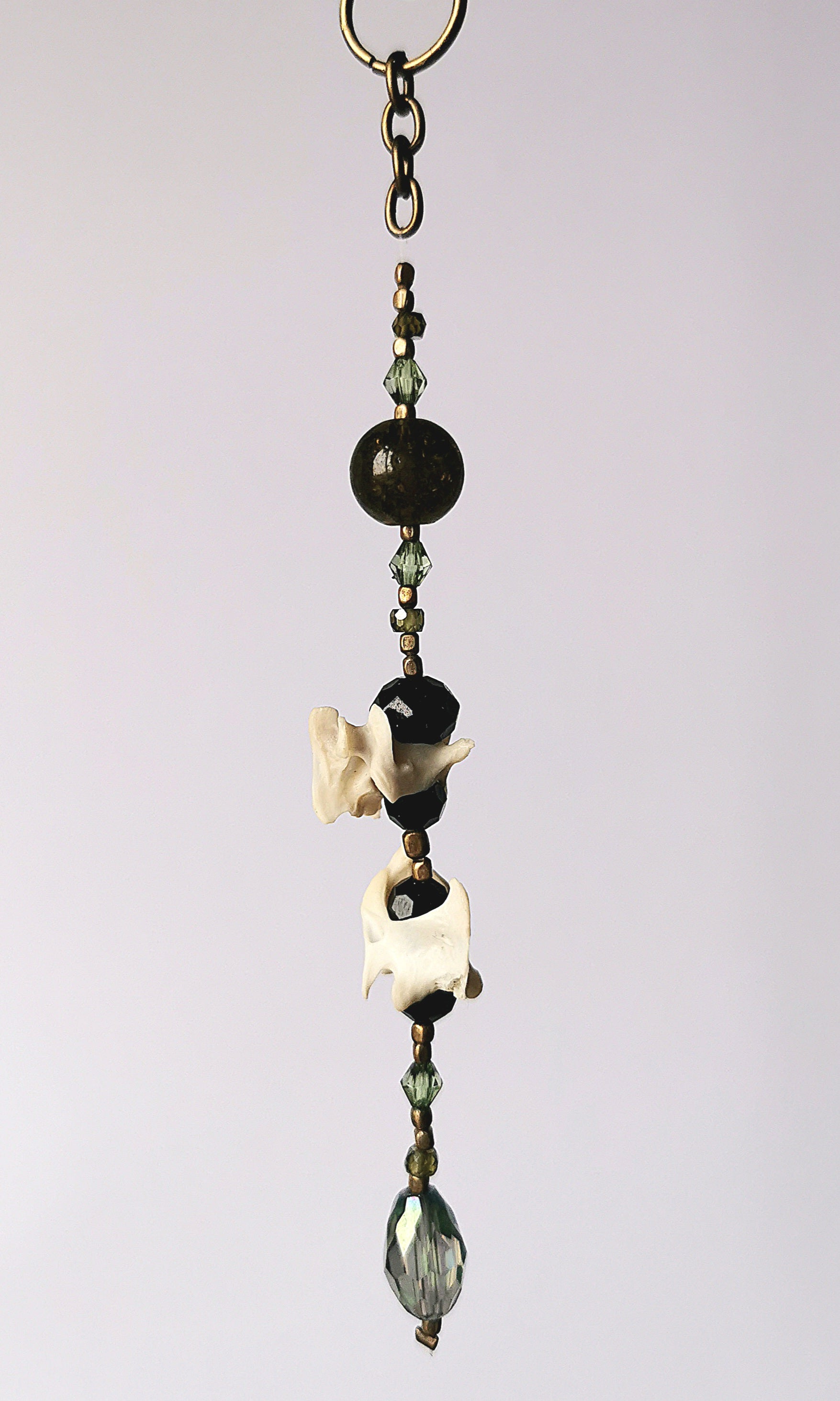 Animal bone suncatcher with green and black beads