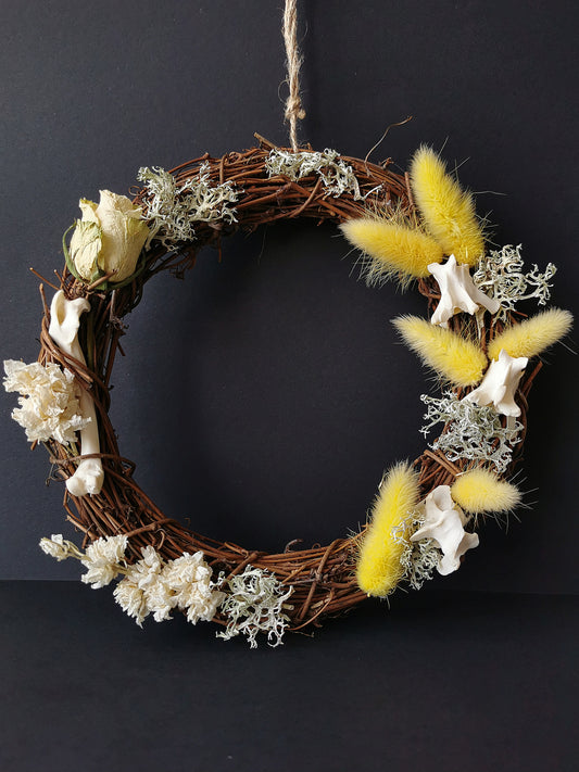 dried flower wreath with bunny tails and animal bones