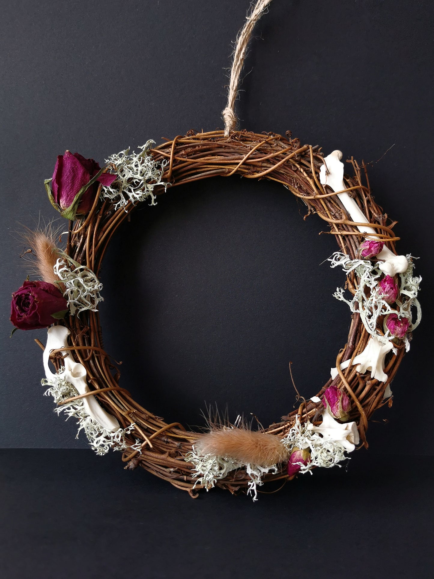 dried flowers roses and animal bones wreath