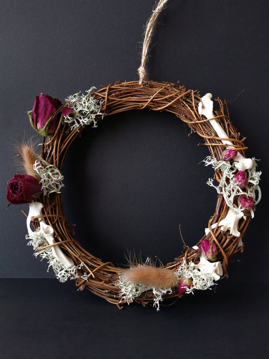 dried flowers roses and animal bones wreath