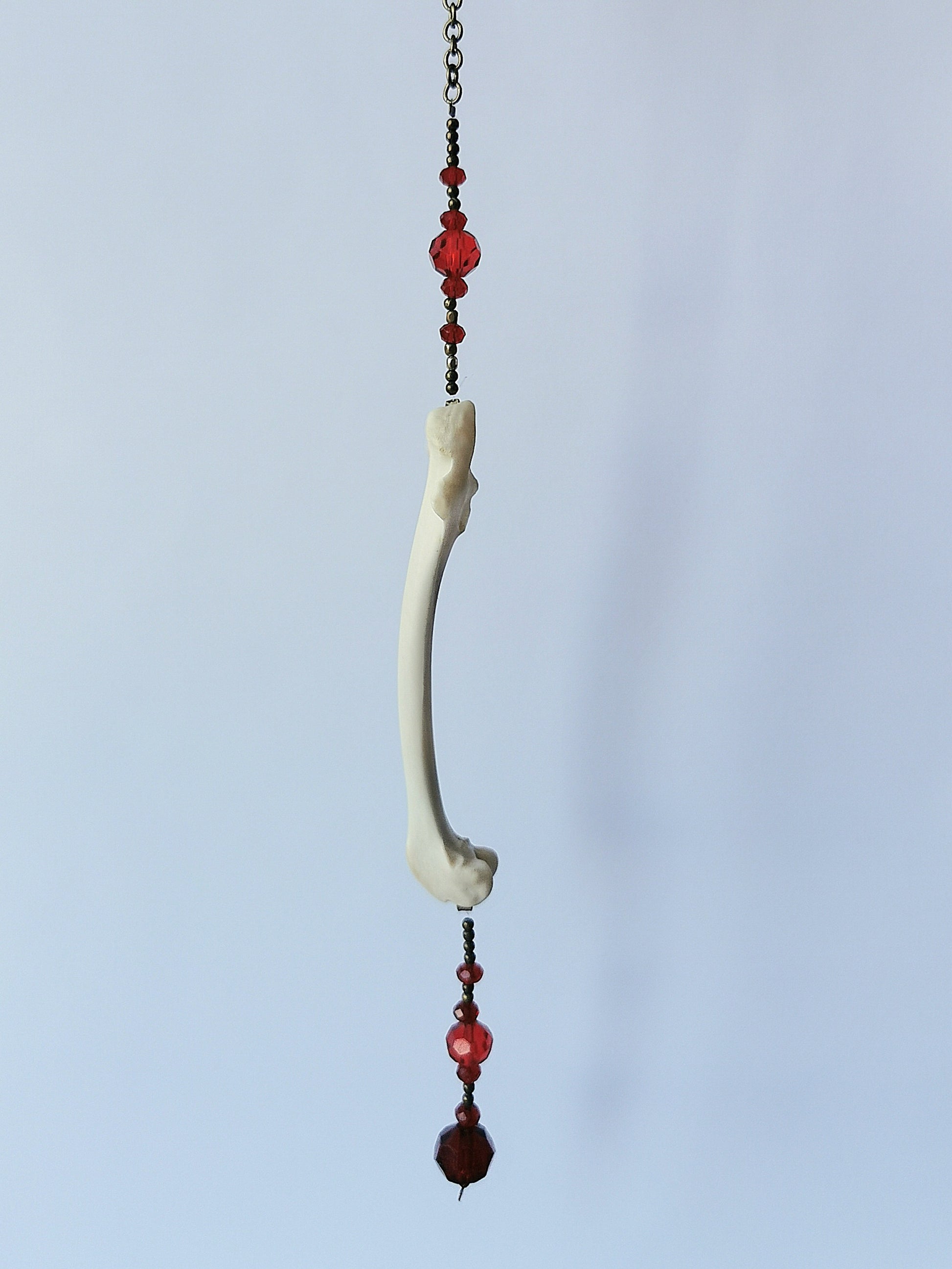 Animal bone suncatcher with red beads